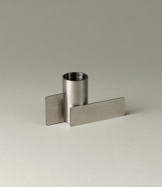 Icon Iysestage 01 from Stences is a candleholder made for taper candles. This picture shows the chrome variant of this item. The steel material has a brushed surface which emphasize the soft geometric shapes of the product in question.